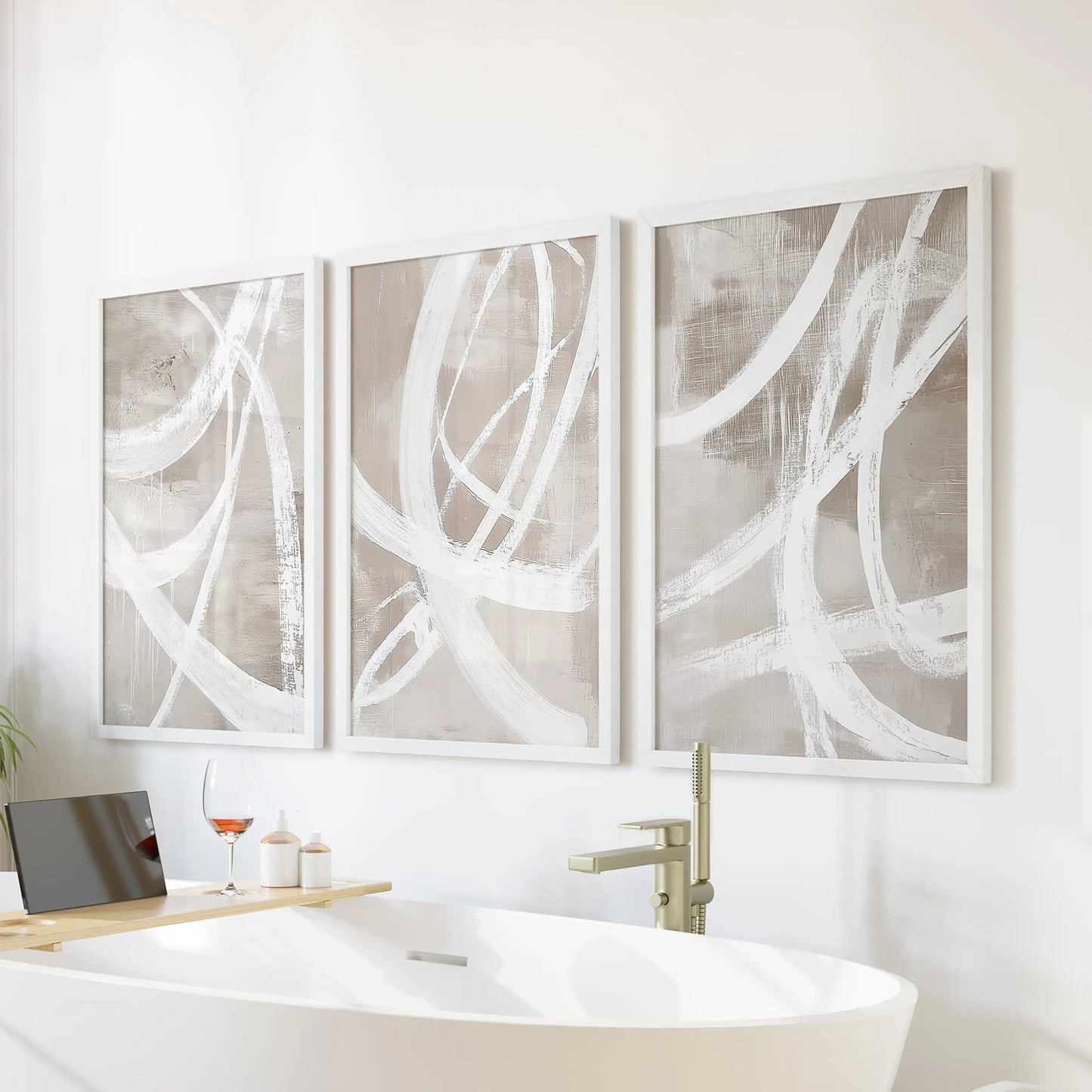 Neutral beige brush strokes art prints, three-piece wall decor set in white frames, float above the tub to calm a light, airy bathroom.