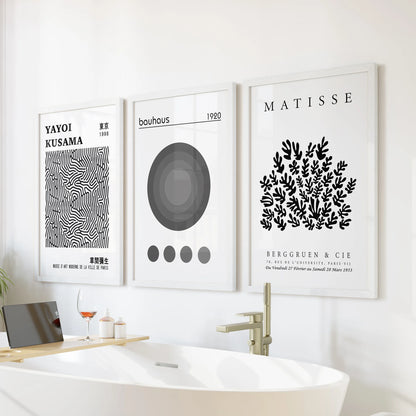 Playful dot artwork in three white-framed pieces brightens the wall over the tub, turning the bathroom into a mini gallery.