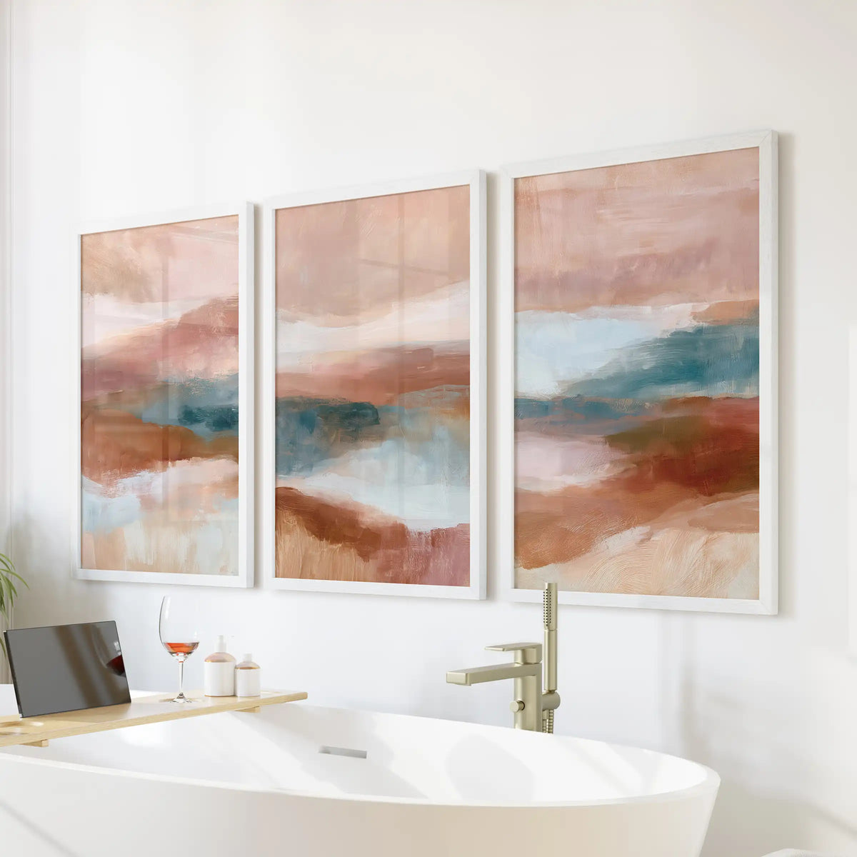 Organic abstract shapes, three coordinating wall art prints in white frames, add calm over the soaking tub in the bathroom.