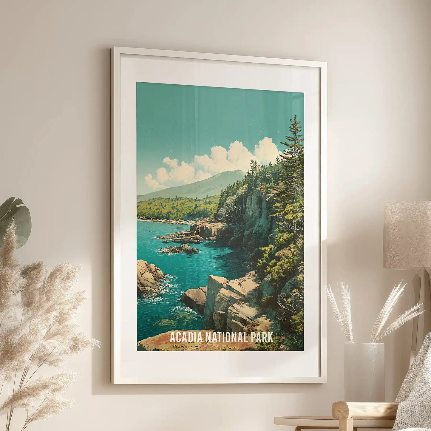 An Acadia National Park poster, white-framed and matted, centers above a reading chair to warm and brighten a quiet sitting room.