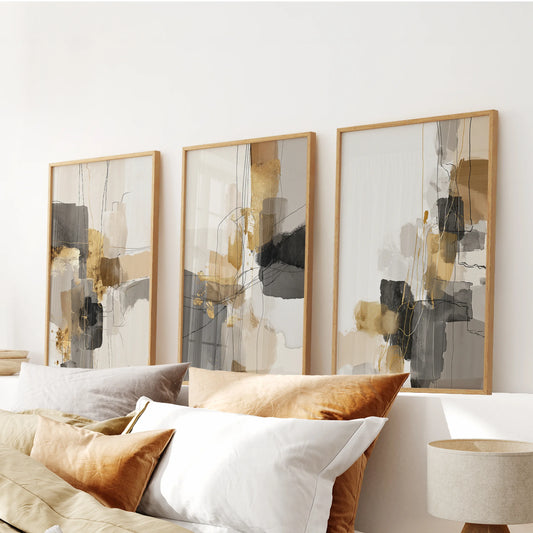 Three light-oak-framed wall panels with soft beige abstractions calm the bedroom space above the bed with quiet, geometric balance.