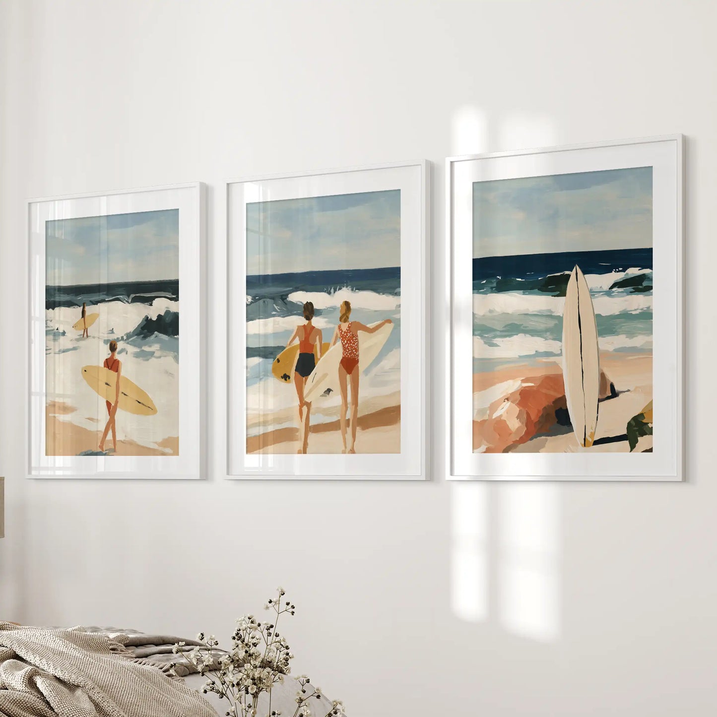 A serene trio of ocean-wave art prints, white-framed and widely matted, steadies the bedroom’s bedside wall with breezy composure.