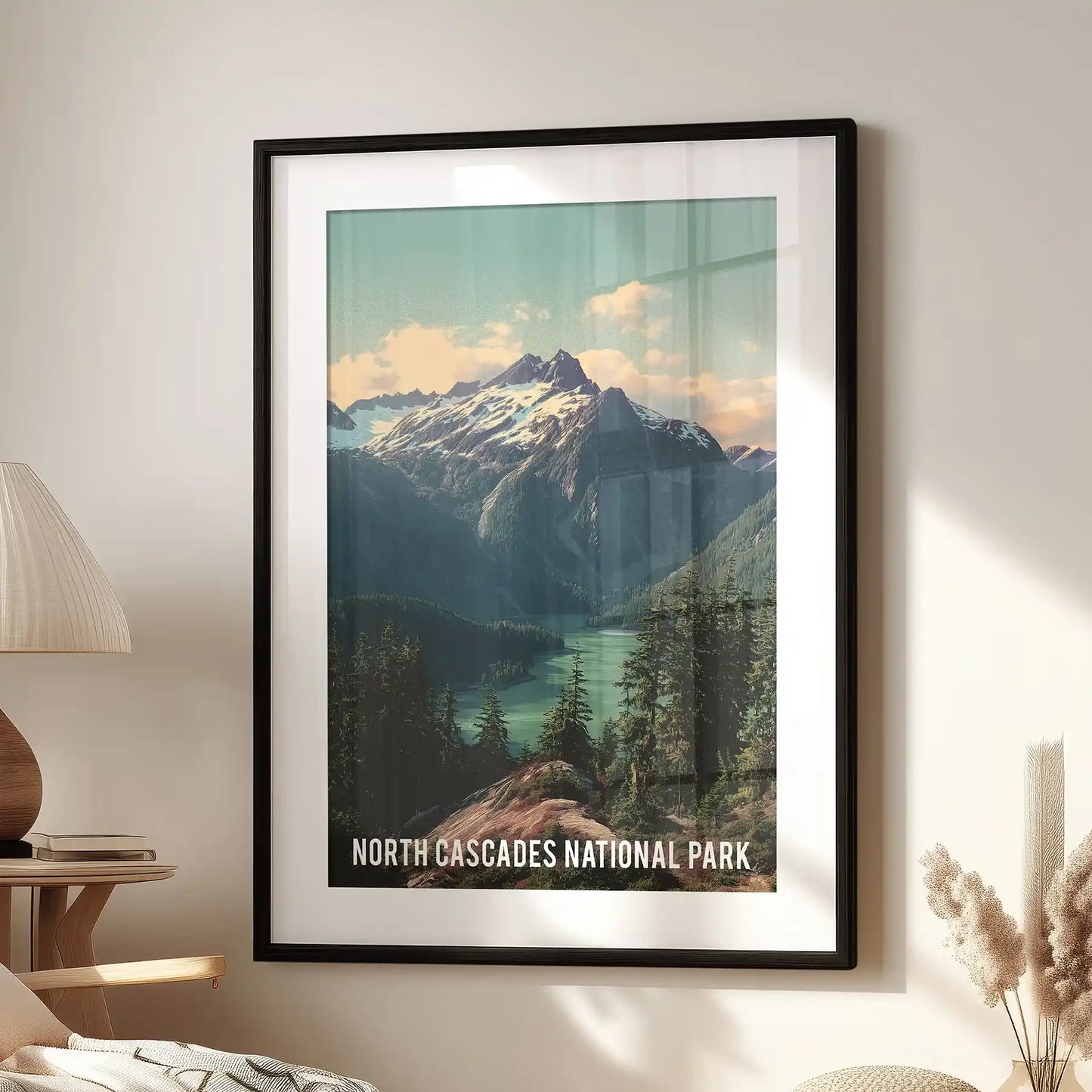 Statement wall decor of glacier-clad Cascades peaks, set in a black frame with mat, hangs above a lounge chair for a crisp alpine focal point.