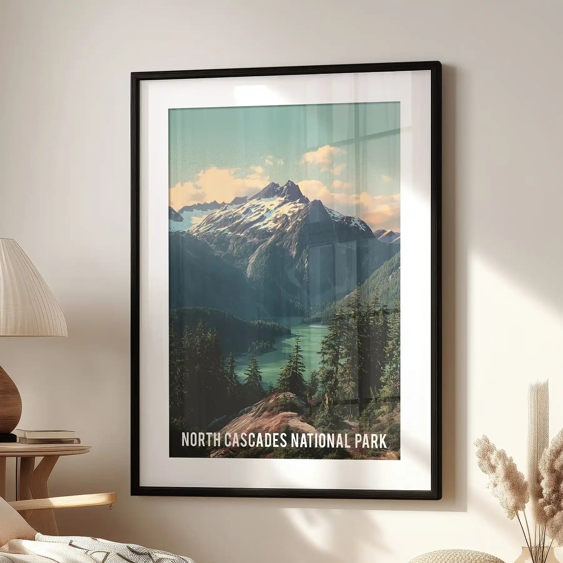 Statement wall decor of glacier-clad Cascades peaks, set in a black frame with mat, hangs above a lounge chair for a crisp alpine focal point.