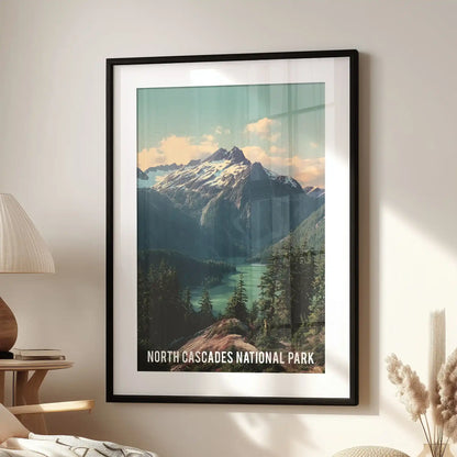 Statement wall decor of glacier-clad Cascades peaks, set in a black frame with mat, hangs above a lounge chair for a crisp alpine focal point.
