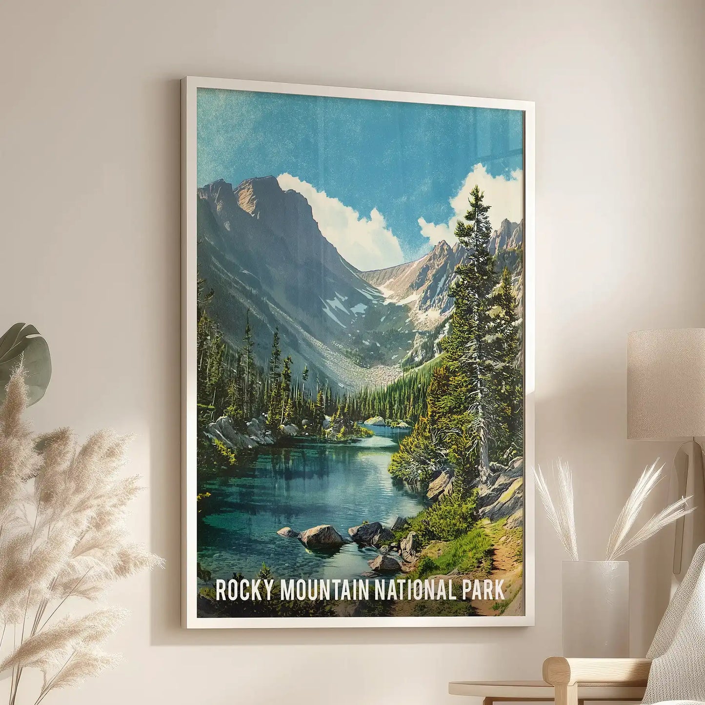 A white-framed art print of subalpine forest scenery glows above the reading chair, giving the sitting room the feel of bright Colorado air.