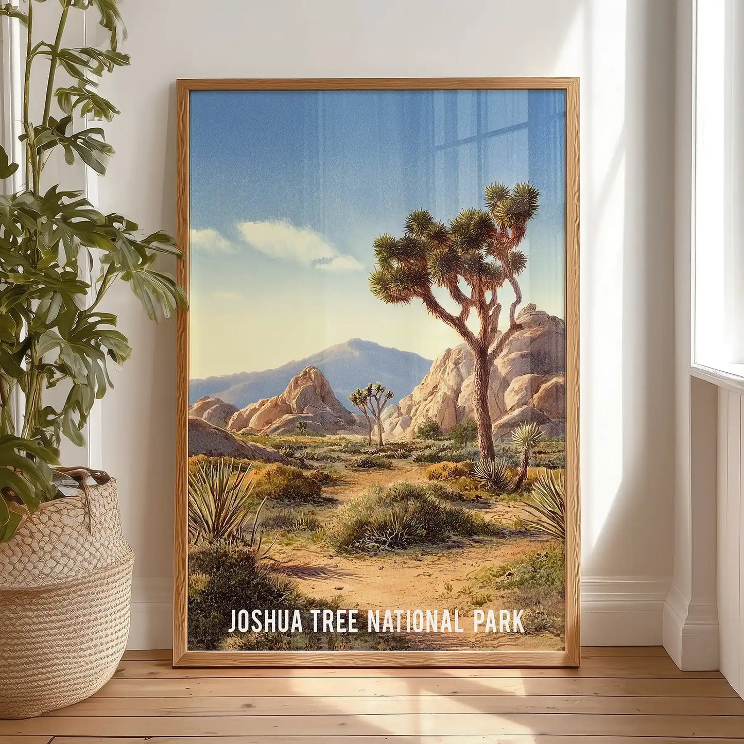 Warm beige desert illustration poster print leans in the bedroom, set in a natural oak frame and propped on the floor by the window for a casual look.