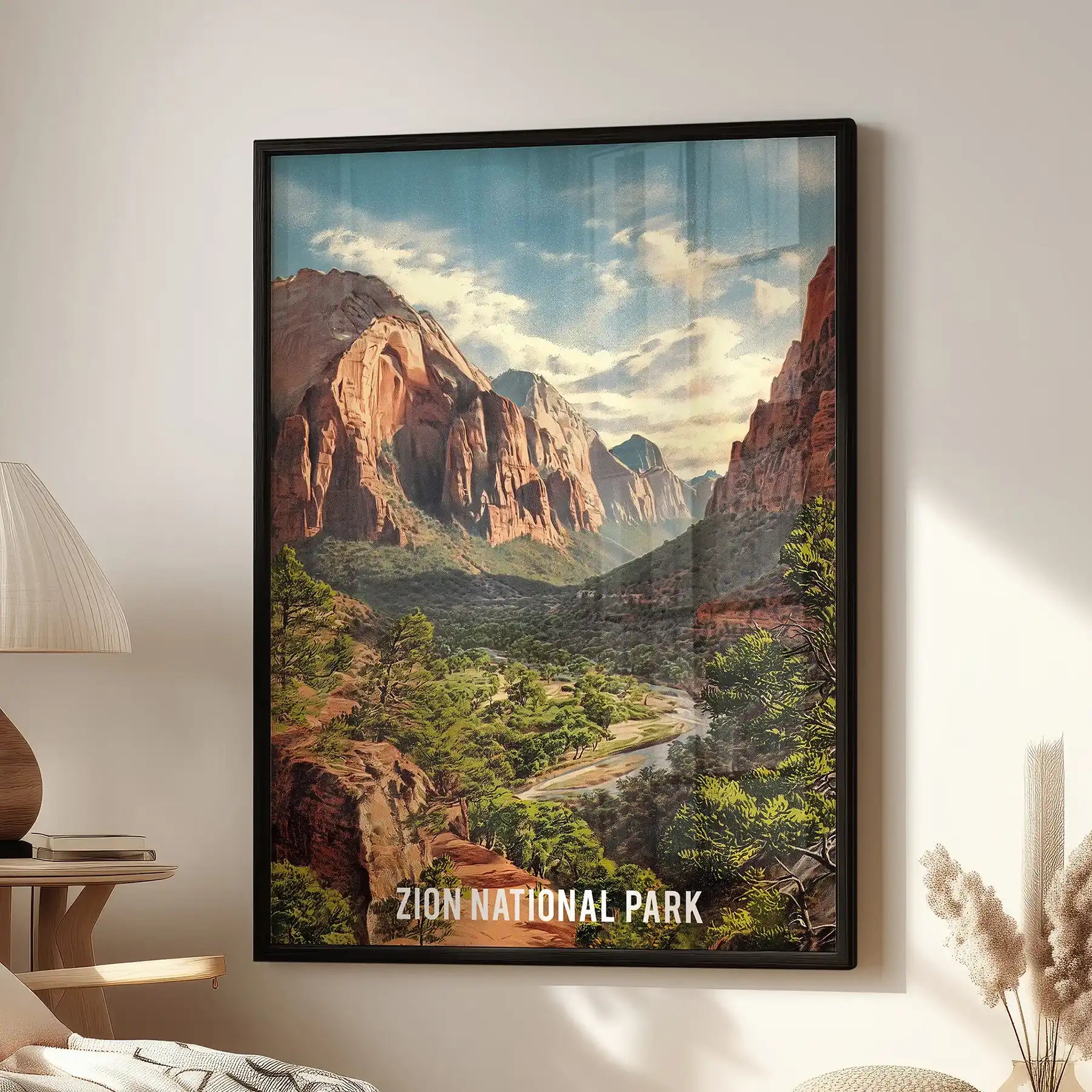Zion National Park home wall art in a black frame anchors the lounge, hanging above a cozy chair with towering sandstone cliffs and the river winding through the canyon.