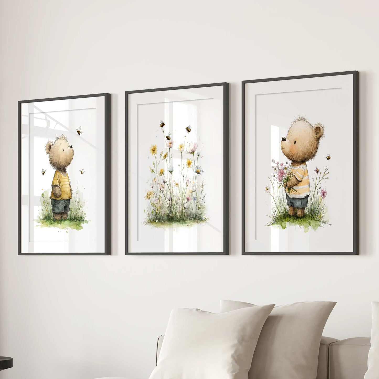 Teddy bear nursery prints, set of 3 posters, bring soft charm to a lounge in black matted frames, styled to hang above a sectional sofa.