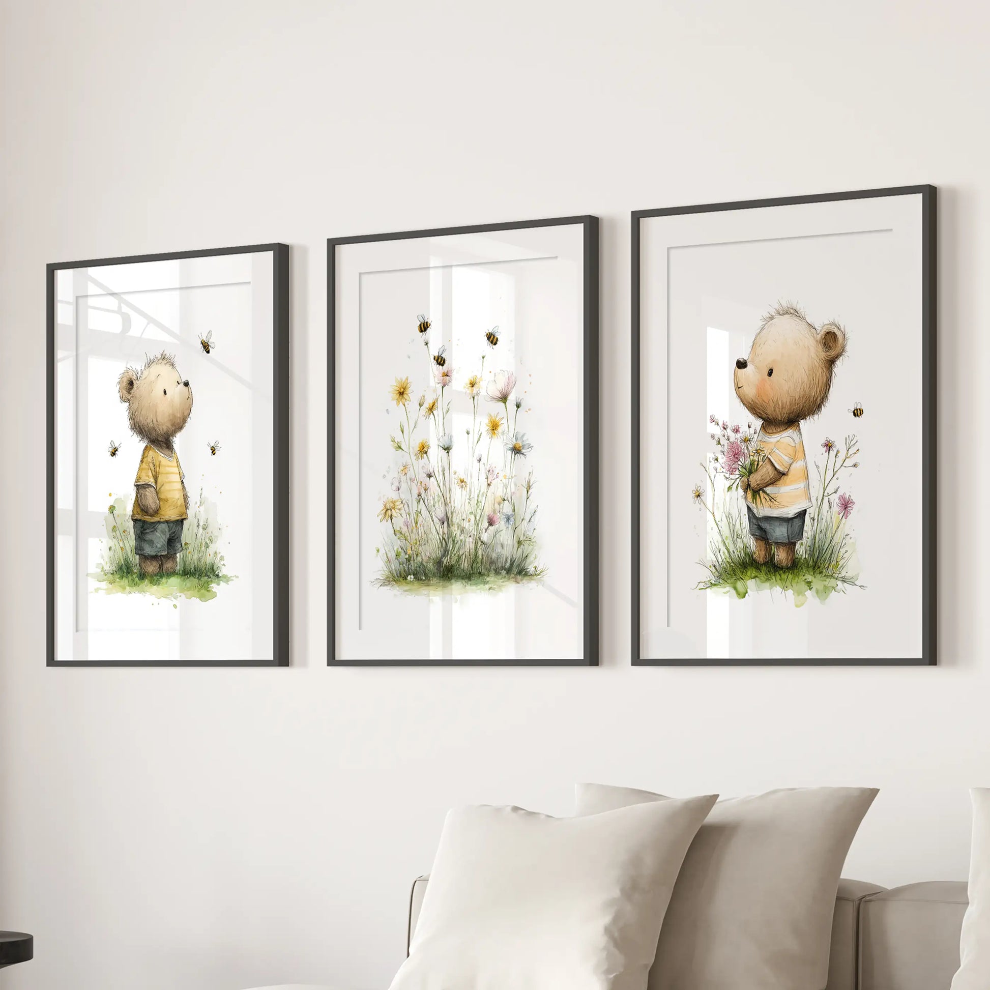 Teddy bear nursery prints, set of 3 posters, bring soft charm to a lounge in black matted frames, styled to hang above a sectional sofa.