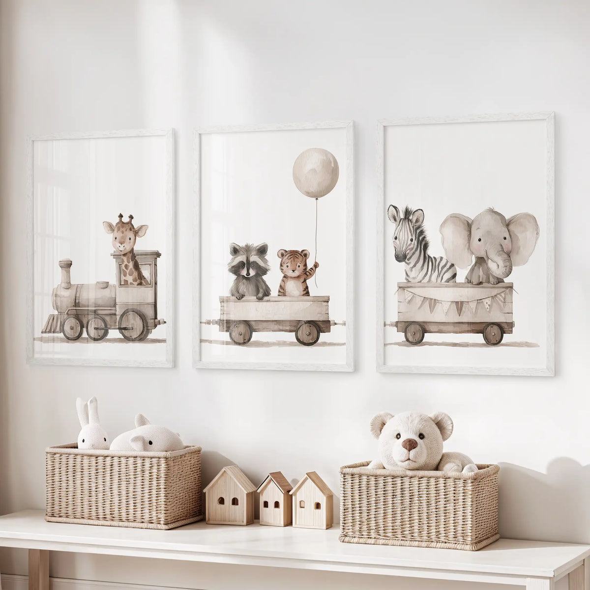 Three animal train prints in white frames above a toy storage bench.