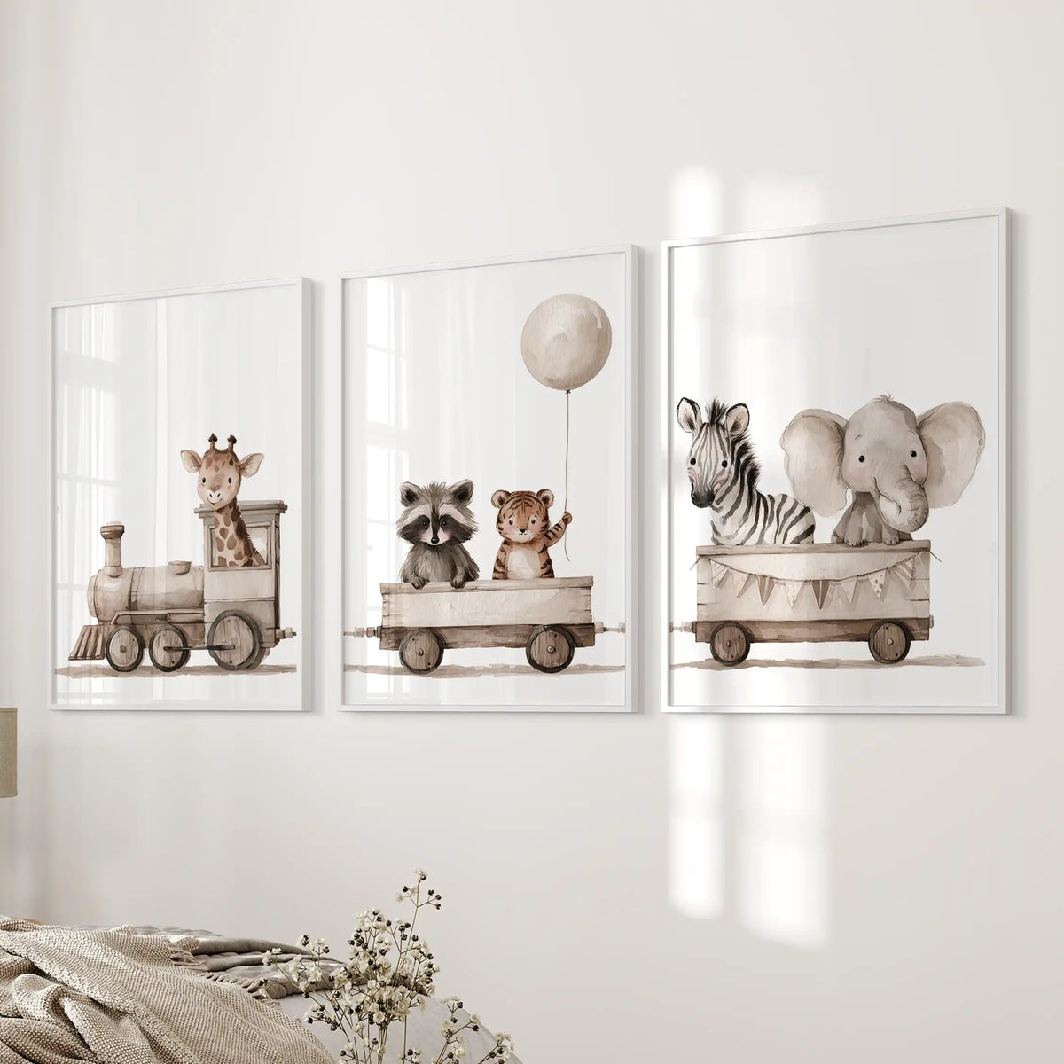 Beside a bed, white frames surround three prints of a giraffe-led train ending with a zebra and elephant.