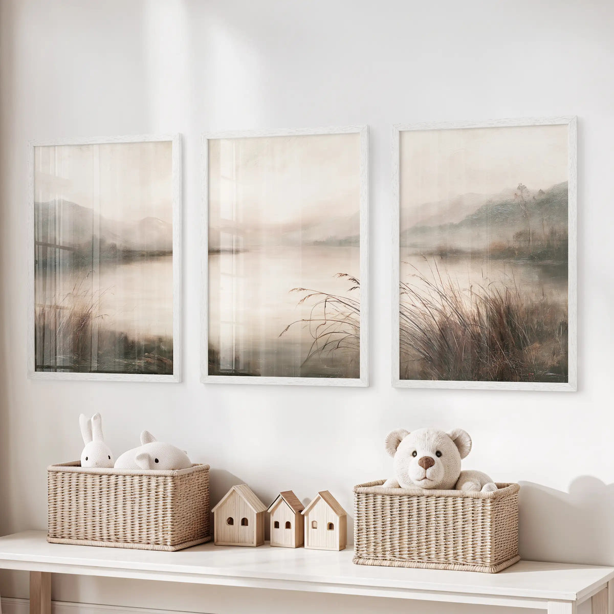 Wall art trio featuring antique nature scenes in white frames, displayed over a toy storage bench in a kids' playroom.