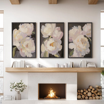 A trio of wall art prints with pink and white peonies crowns the sitting room mantel in slim black frames, giving a vintage floral allure.
