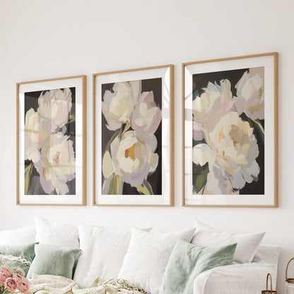Across the family-room sectional, a set of three peony prints in thin wood frames with mats offers a refined yet comfortably aged look.