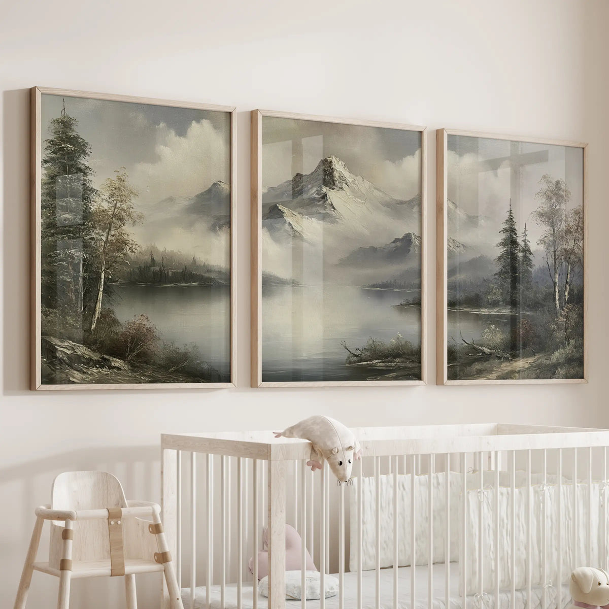 Antique wilderness landscape print trio wall set in solid oak frames, displayed above a bassinet in a nursery.