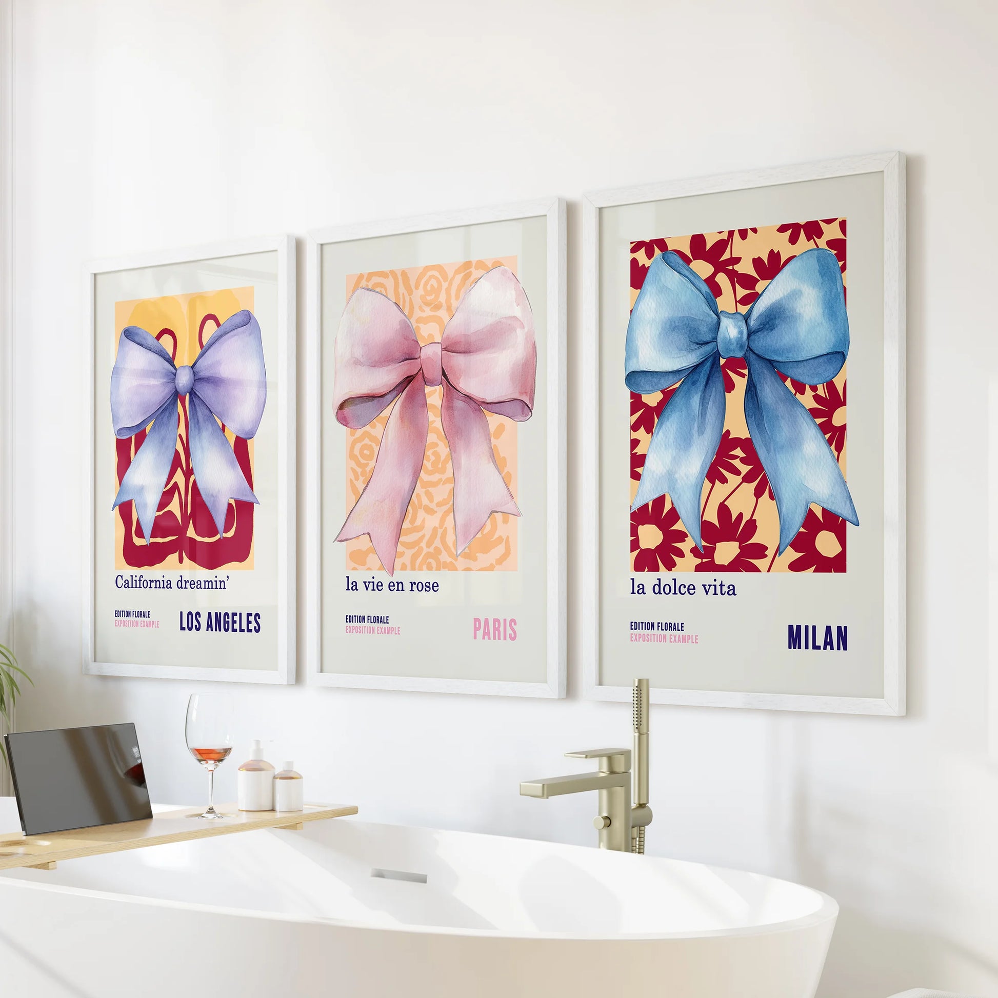 Girly ribbon bow art, set of three wall art prints in crisp white frames, brings a lighthearted accent above the bathroom bath without overwhelming the space.