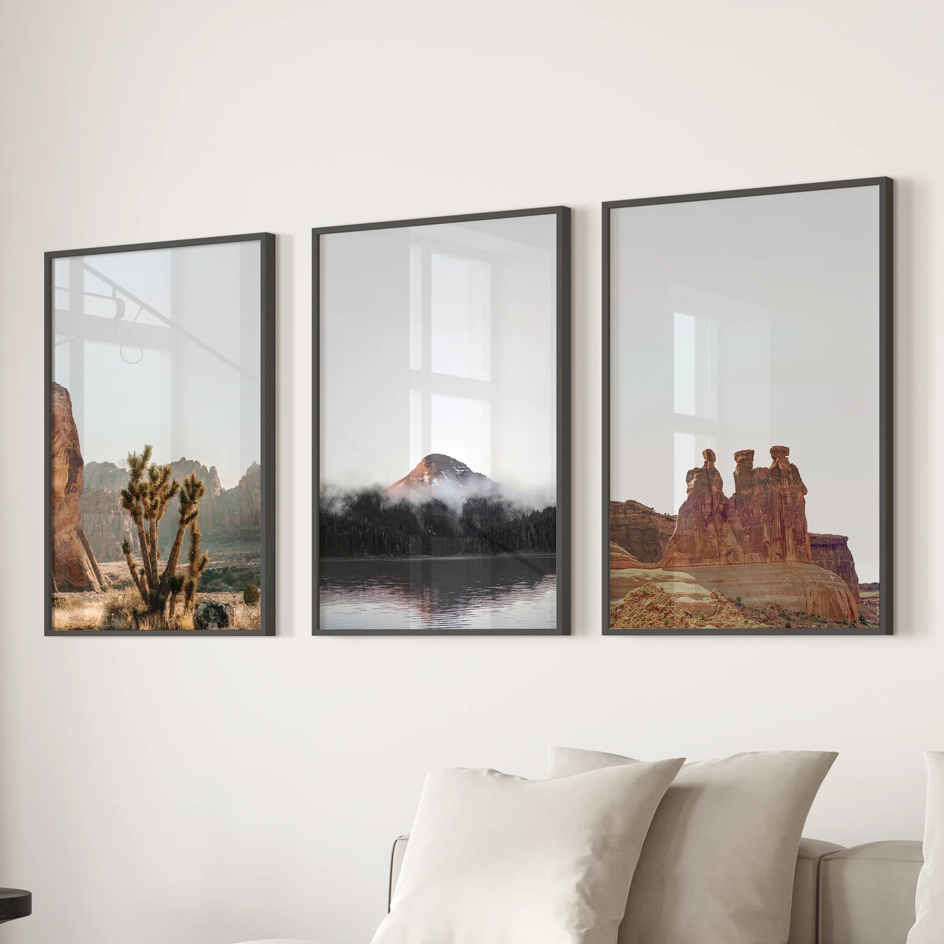 Southwest desert landscape wall art trio in black-framed prints spans the lounge, hanging over the sectional sofa as a clean, grounded focal point.