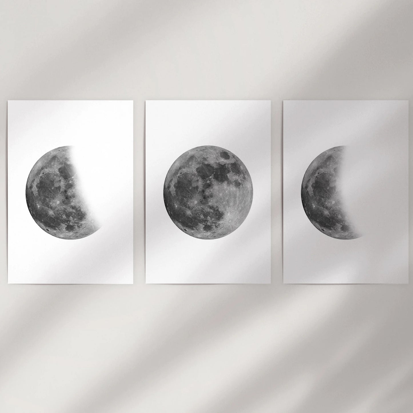 Black and white moon photography 3-piece print set, delivered as unframed posters to fill a blank wall with stark, space-toned lunar art.