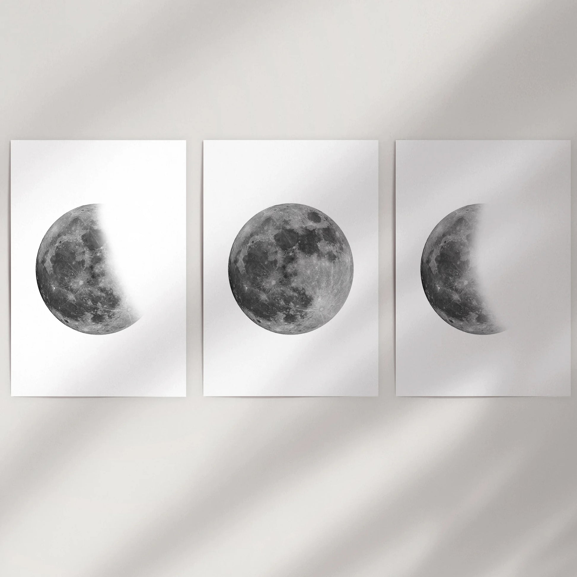Black and white moon photography 3-piece print set, delivered as unframed posters to fill a blank wall with stark, space-toned lunar art.