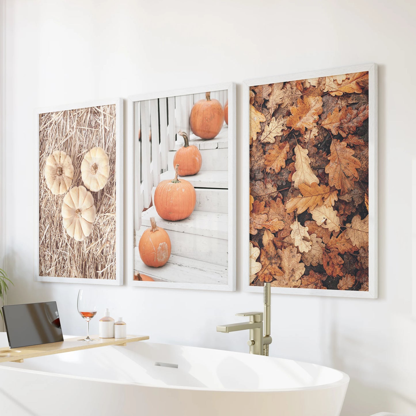 Pumpkin triptych set of 3 pictures, white framed above a freestanding tub, brings soft autumn warmth to bathroom walls with serene pumpkin photography.