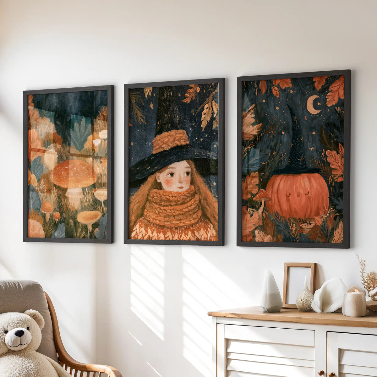 A storybook cottagecore forest fills this three-piece wall art set, hung in black frames over the dresser in a children's room.