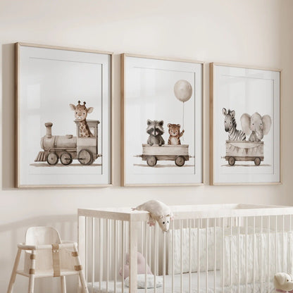 Animal train prints in three matted oak frames hang above a crib.