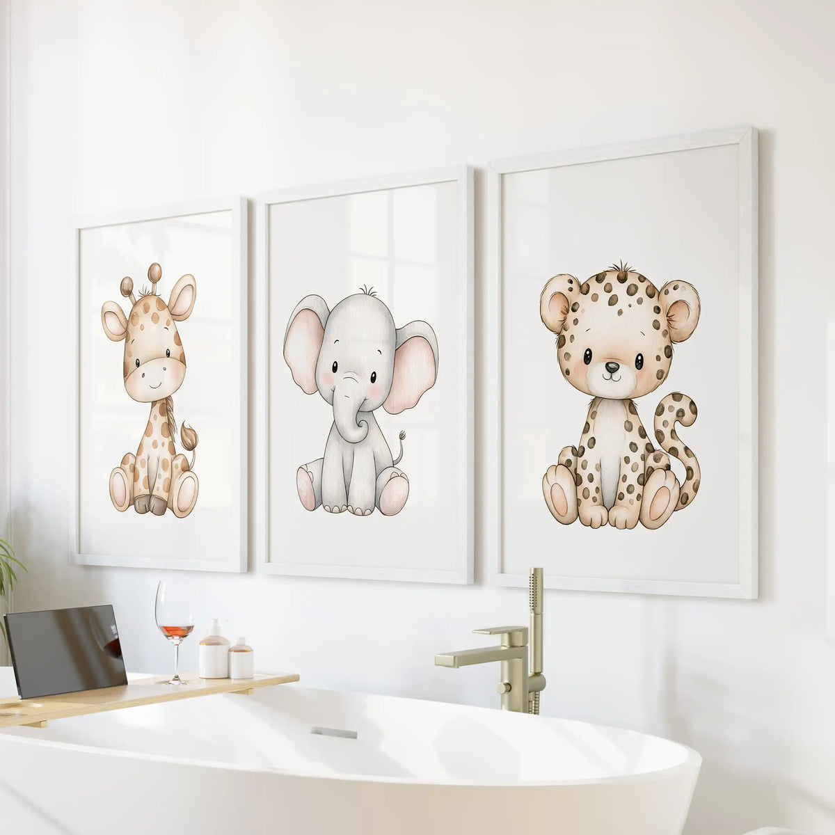 Above a freestanding bathtub, white frames surround three prints of a baby giraffe, elephant and spotted leopard.