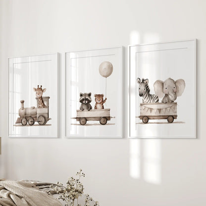 A giraffe in an engine and two animal-filled train cars appear in three prints, framed in white with mats beside a bed.