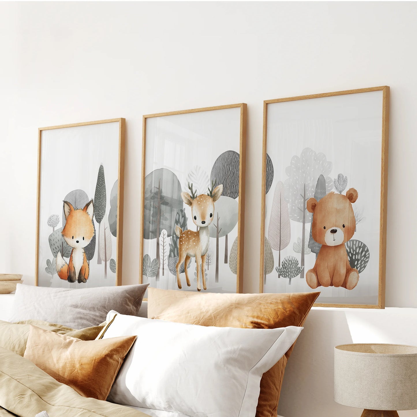 Woodland animal trio in a 3-piece poster set, oak-framed for a warm finish, centers the bedroom wall over the bed.