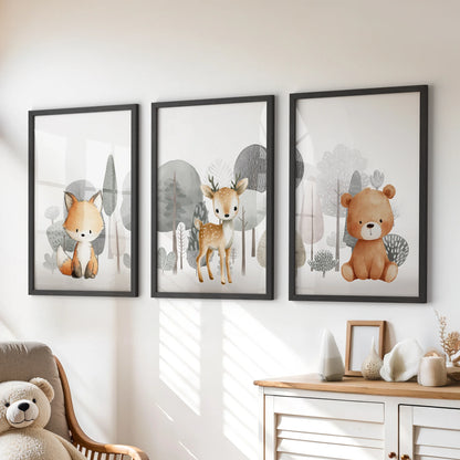 Three small animal prints in black frames hang over the playroom chest, forming a tidy trio of cheerful woodland art.