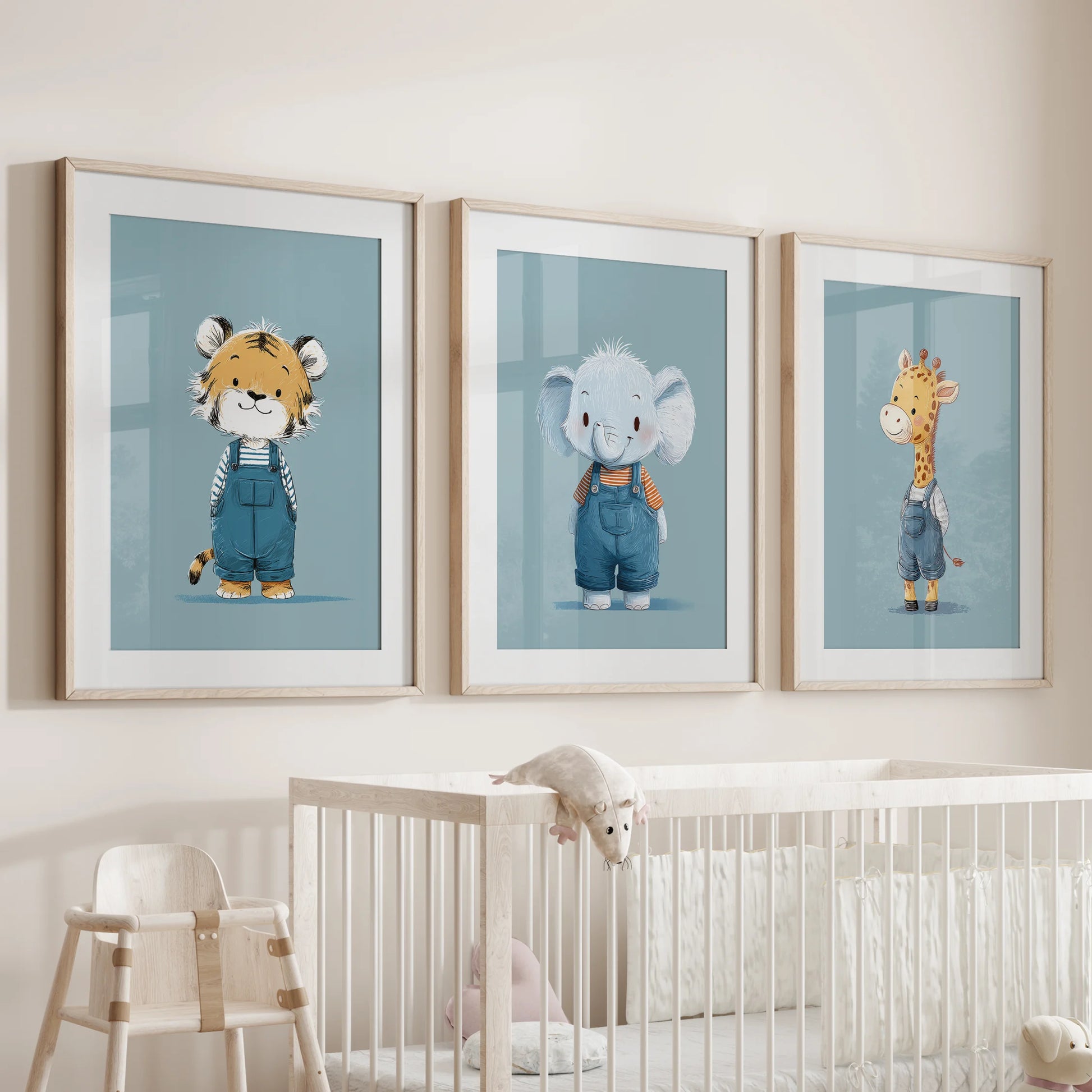 Giraffe, tiger, and elephant trio, a 3-print nursery wall set in oak frames with mats, arranged over the cot to bring soft blue charm.