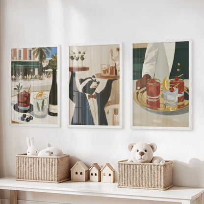 Bar cart artwork in a three-piece wall picture set, displayed in white frames above a toy storage bench in the playroom.
