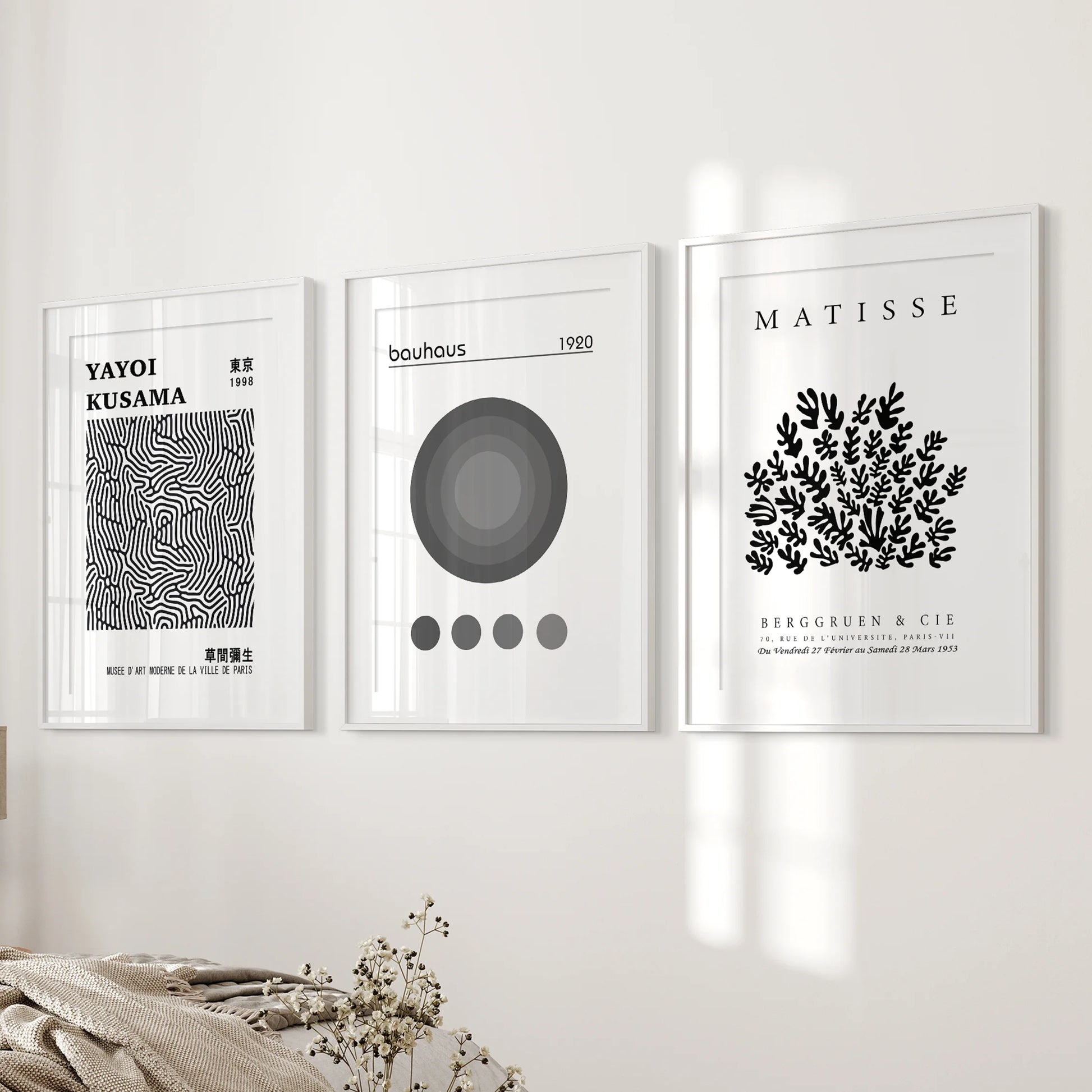 Bauhaus geometric posters, gallery of three, sit near the bed wall in the bedroom, set in white frames with matting for a refined, balanced spread.