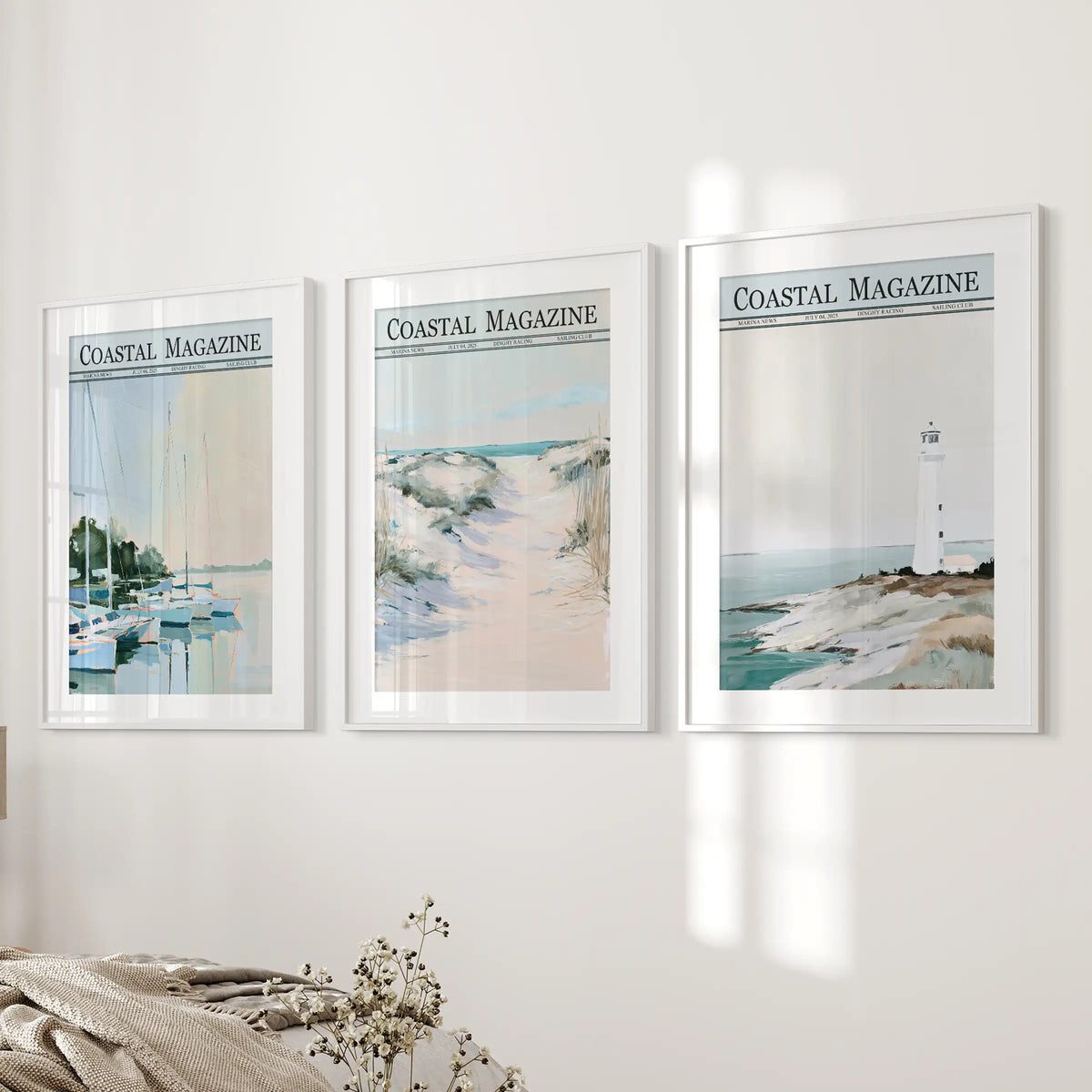 Seaside scenery 3-piece wall art print set in white frames with white mats, displayed on a bedroom wall above the bed.