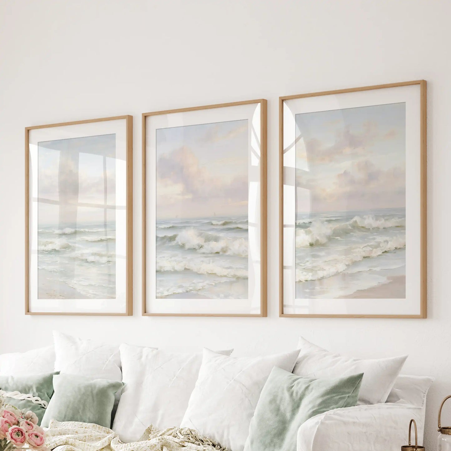 A wooden-framed wall art trio with mats brings soft ocean rhythm and relaxed polish to the family room behind the couch.