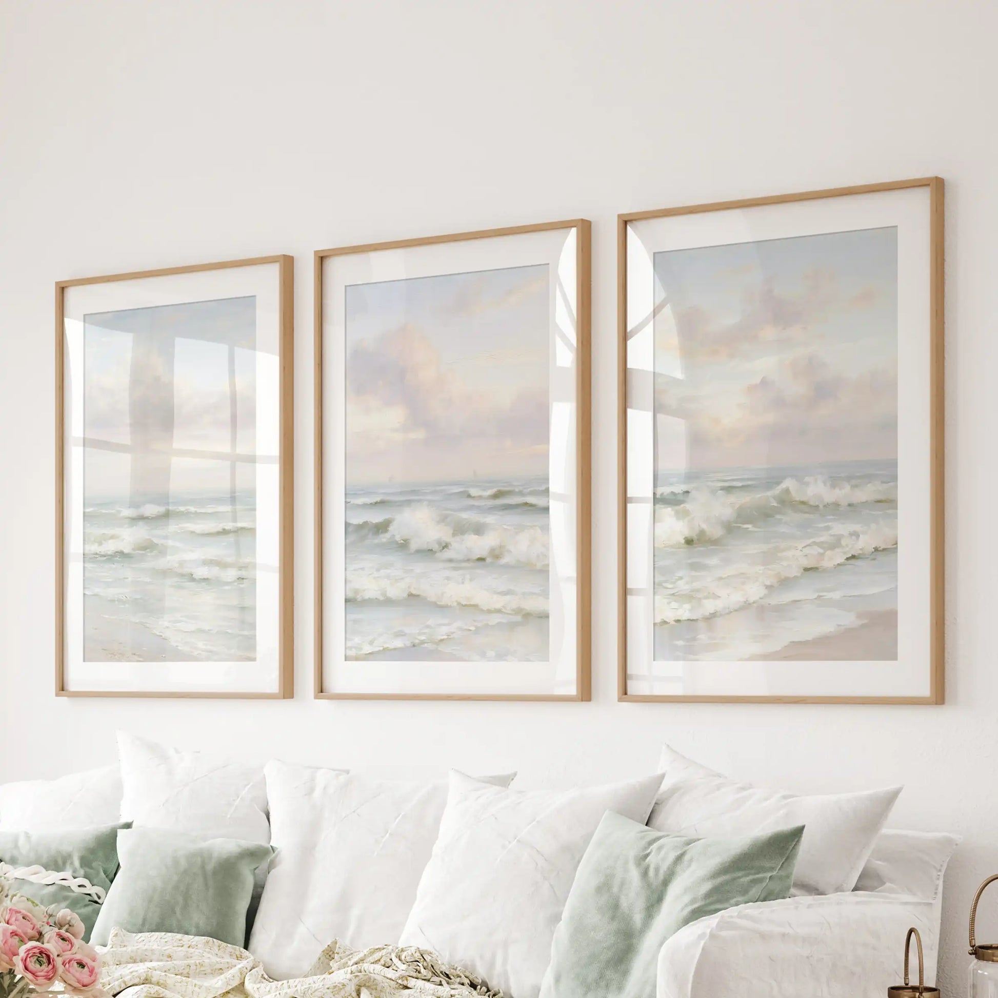 A wooden-framed wall art trio with mats brings soft ocean rhythm and relaxed polish to the family room behind the couch.