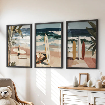 Three framed coastal beach artworks in black sit over the playroom dresser, adding sky blues and sandy neutrals to the space.