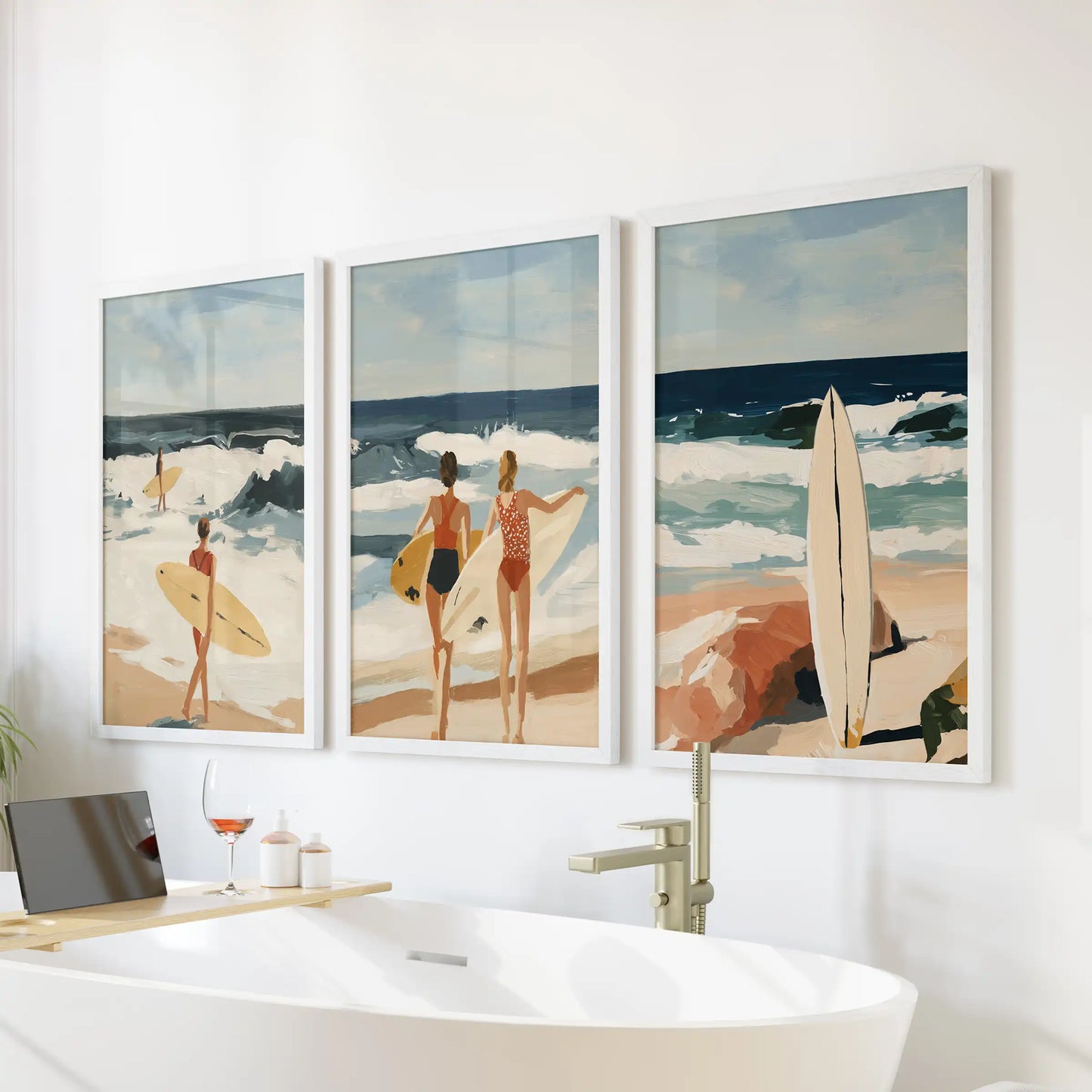 Surfer girl wall art set of 3 posters, in crisp white frames, floats above a freestanding tub to bring soft coastal motion into the bathroom.