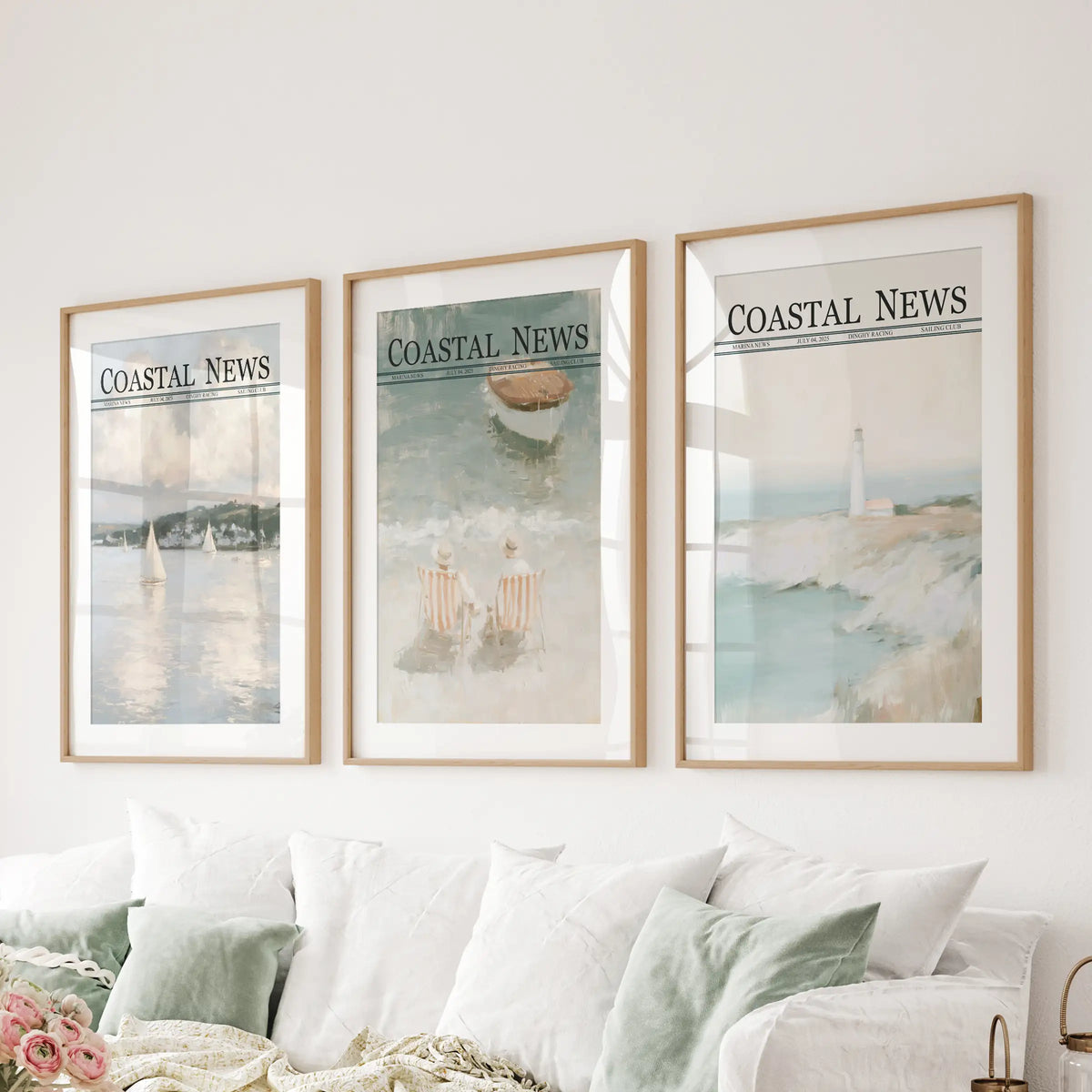 Seaside scenes make up a wall art trio in matted wooden frames, displayed behind a couch in a family room.