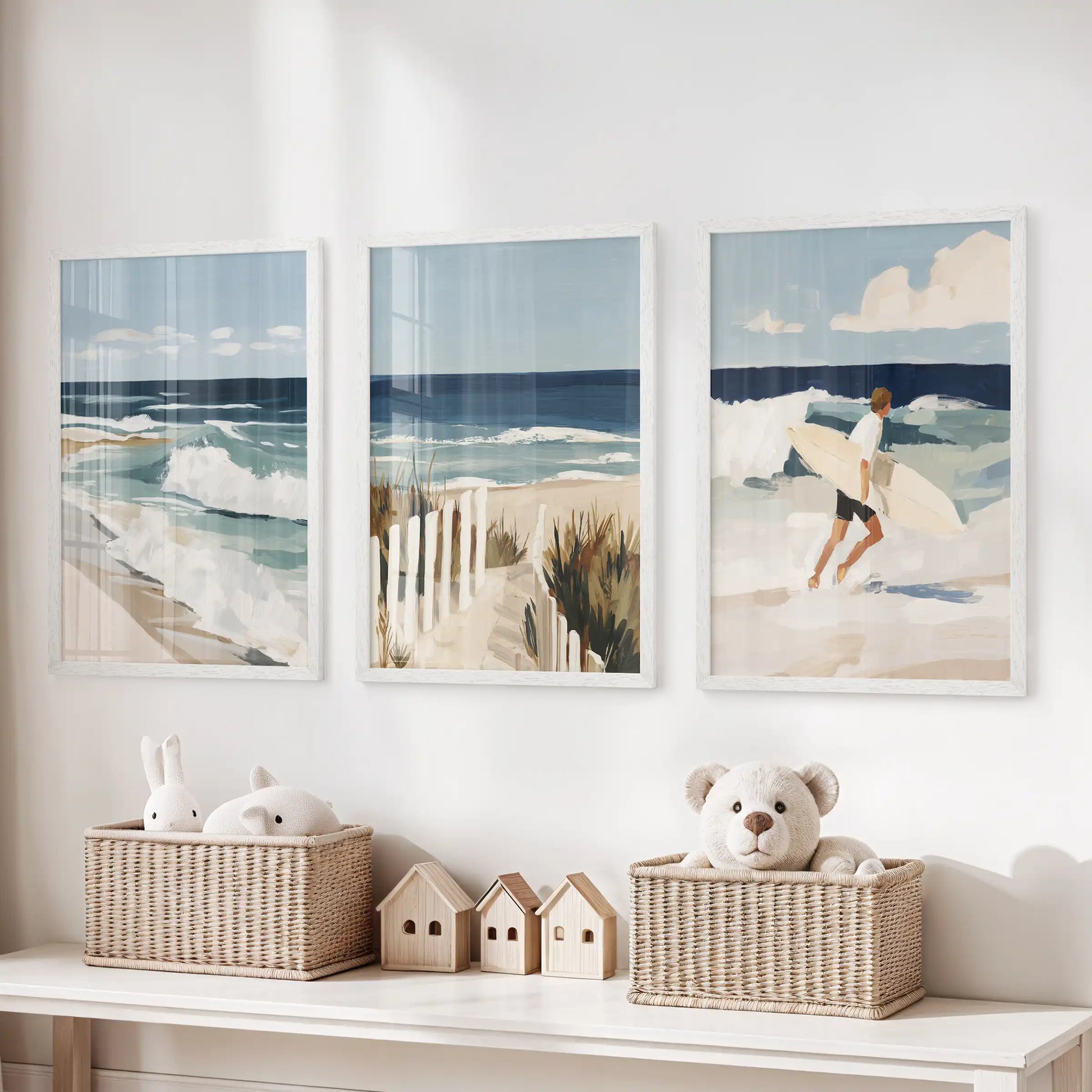 Three coastal cottage artworks in white frames brighten the kids’ room, hanging above toy storage to spark breezy daydreams.