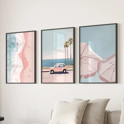 Slim black-framed wall art of pink coastal beach scenes forms a bright 3-panel centerpiece behind the sofa in the family room.