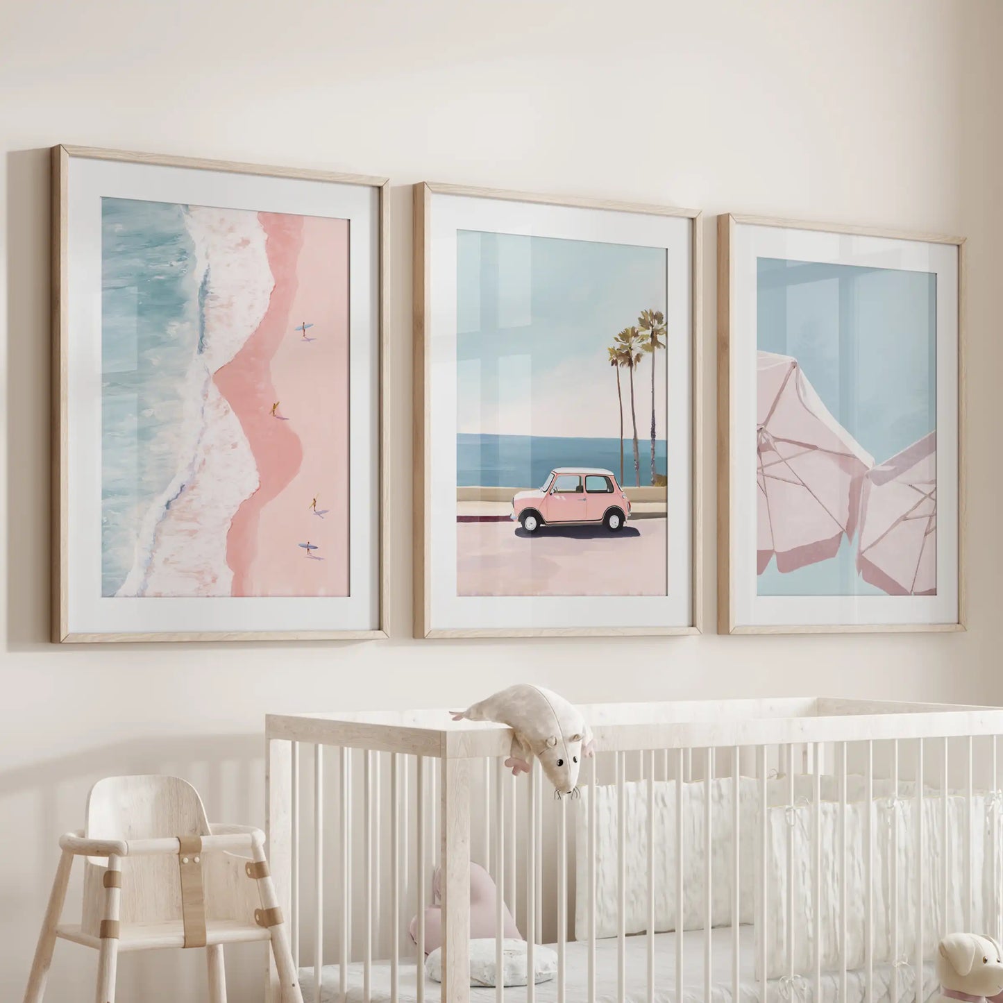 A trio of palm tree prints in natural oak frames with mats lends gentle tropical charm above the cot in the infant room.