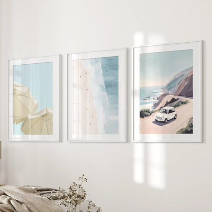 Ocean shoreline gallery wall, a 3-piece suite of white-matted, white-framed prints, layers calm beside the bedroom wall next to the bed.