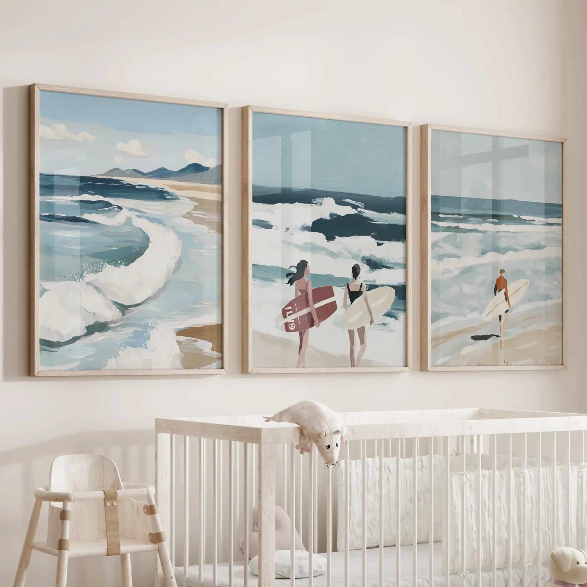 Beach shoreline triptych in light wood frames sits above the cot, bringing soft coastal tones to the infant’s room.