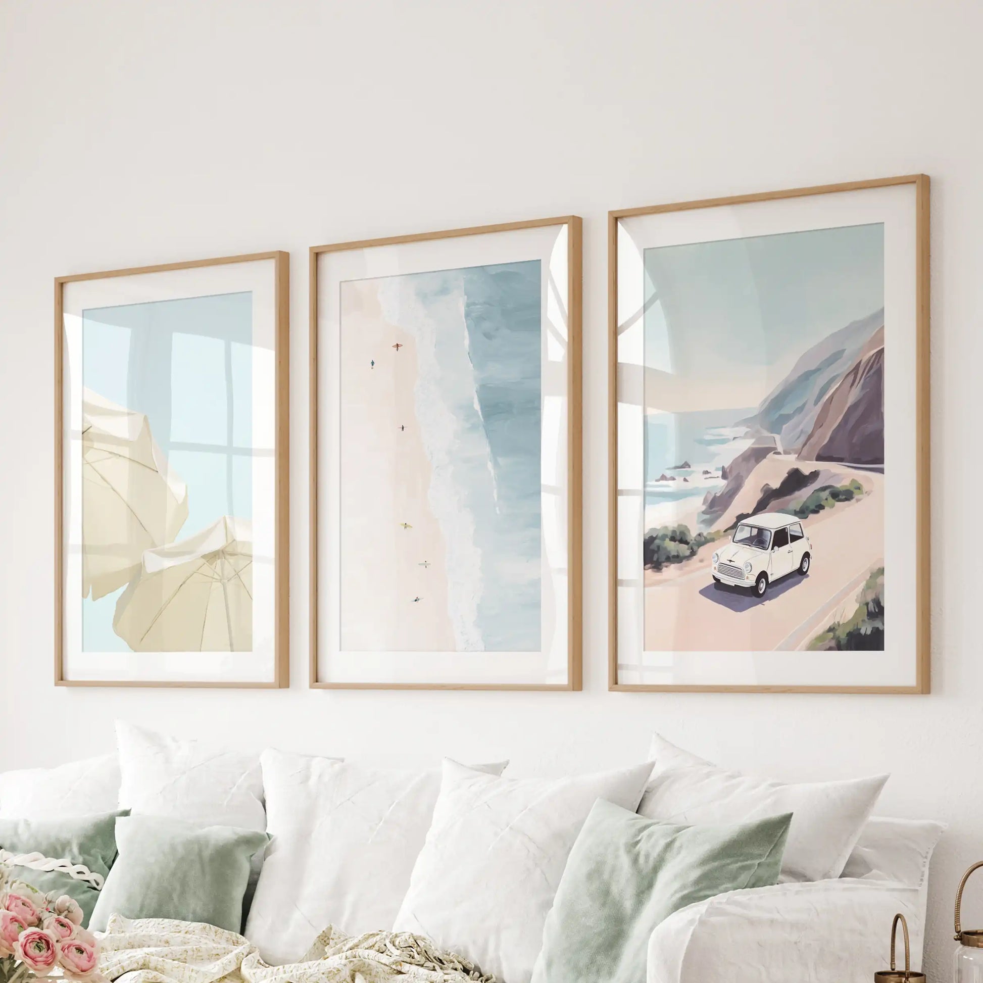 A wood-framed three-piece coastal picture set extends a breezy line behind the living-room sofa.