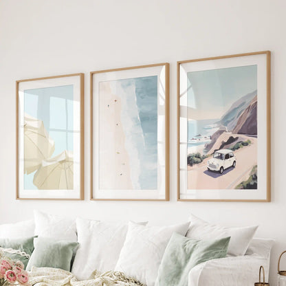 A wood-framed three-piece coastal picture set extends a breezy line behind the living-room sofa.