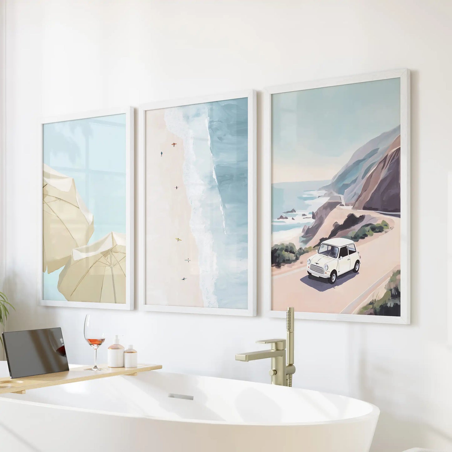Three white-framed beach-umbrella pictures bring seaside cheer to a bathroom wall, brightening the space above the tub.