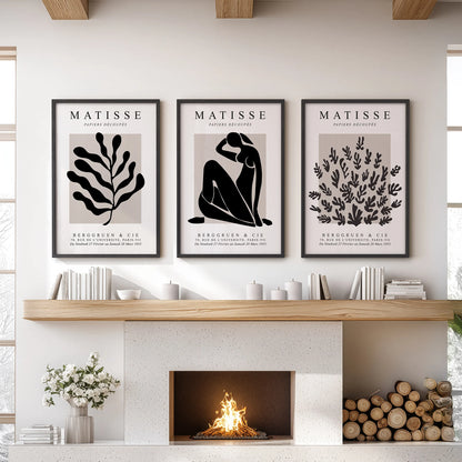 Three framed wall prints with Matisse-style cut-outs create a modern centerpiece above the sitting room fireplace mantel.