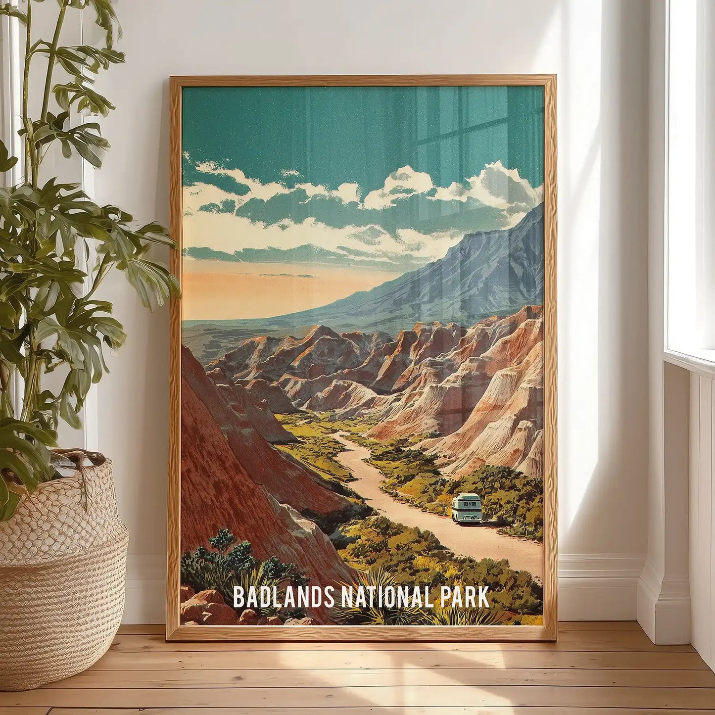 Beige and blue mountain ridges wall print warms the bedroom, set in a light wood frame and shown standing against the wall for a relaxed look.